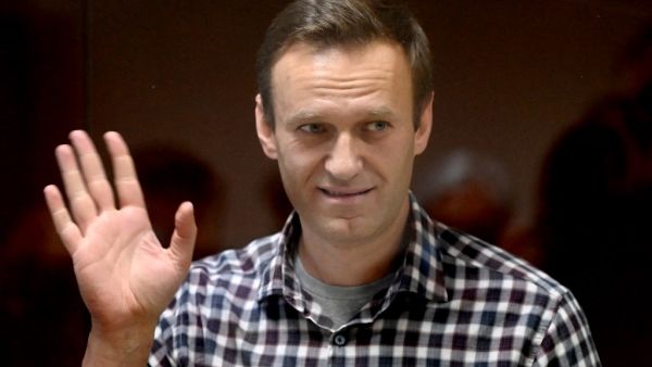 Russian opposition leader Alexei Navalny stands inside a glass cell during a court hearing at the Babushkinsky district court in Moscow on February 20, 2021. The Kremlin's most prominent opponent Alexei Navalny faces two court decisions on Saturday that could seal a judge's ruling to jail him for several years, after he returned to Russia following a poisoning attack. Kirill KUDRYAVTSEV / AFP