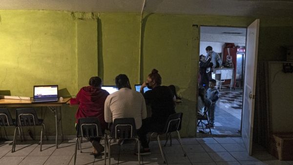 Emma Moreno (R), a volunteer working at the Agape shelter, checks the "Conecta" website of the United Nations High Commissioner for Refugees (UNHCR), to help asylum seekers request appointments and await asylum processes in the US, in Tijuana, Baja California state, Mexico on February 20, 2021. Guillermo Arias / AFP Emma Moreno (R), a volunteer working at the Agape shelter, checks the "Conecta" website of the United Nations High Commissioner for Refugees (UNHCR), to help asylum seekers request appointments and await asylum processes in the US, in Tijuana, Baja California state, Mexico on February 20, 2021. Guillermo Arias / AFP