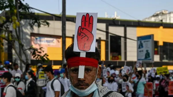 A protesters wears a sign with the three finger salute during a demonstration against the military coup in Yangon on February 22, 2021. Ye Aung THU / AFP
