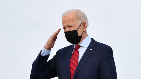 US President Joe Biden salutes as he boards Air Force One before departing from Andrews Air Force Base in Maryland on February 27, 2021. The Bidens travel to Wilmington, Delaware, to spend the weekend. MANDEL NGAN / AFP