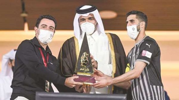 Sheikh Joaan bin Hamad al-Thani presents the Qatar Cup trophy to Al Sadd captain Hassan al-Haydos (right) and coach Xavi Hernandez (left). (Photo: Noushad Thekkayil)