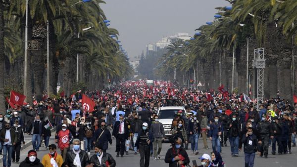 Supporters of the Islamist Ennahdha party wave flags 