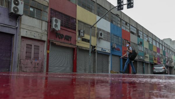 View of closed stores and empty streets after non-essential services were shut down at midnight and until March 20 in the state of Sao Paulo, amid the novel coronavirus COVID-19 pandemic, in Sao Paulo, Brazil, on March 6, 2021. Brazil's biggest state, Sao Paulo, declared new "red phase" restrictions over COVID-19 on Wednesday, ordering non-essential businesses closed for two weeks as an explosion of cases swept the country. The partial lockdown, which came into force effect March 5 at midnight, (0300 GMT Saturday), bars all but "essential activities" in the state of 46 million people. Miguel SCHINCARIOL / AFP View of closed stores and empty streets