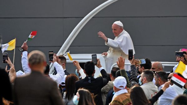 Pope Francis blesses people as he arrives in the popemobile vehicle at the Franso Hariri Stadium in Arbil, on March 7, 2021, in the capital of the northern Iraqi Kurdish autonomous region. Pope Francis, on his historic Iraq tour, visits today Christian communities that endured the brutality of the Islamic State group until the jihadists' "caliphate" was defeated three years ago. Vincenzo PINTO / AFP