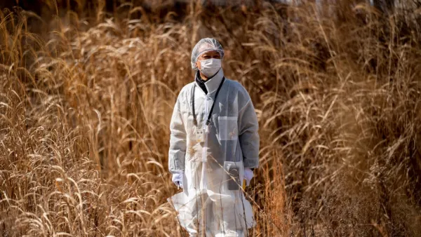Reverend Akira Sato in a protective suit 