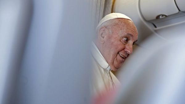 Pope Francis speaks to reporters during a news conference while in the air aboard the Alitalia papal plane on his flight back from Iraq