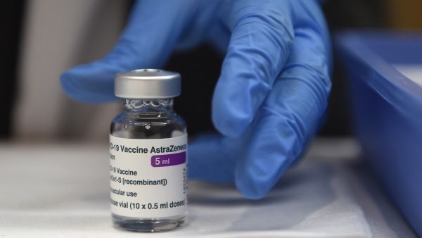 A nurse picks up a bottle of the AstraZeneca Covid-19 vaccine during a mass vaccination campaign for people between ages of 50 to 55 in Vigo, northwestern Spain, on March 13, 2021. MIGUEL RIOPA / AFP Spain probes death of teacher after AstraZeneca vaccine