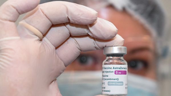 A nurse holds a vial of the Oxford-AstraZeneca vaccine 