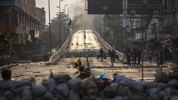 Protesters carry tires to construct makeshift barricades 