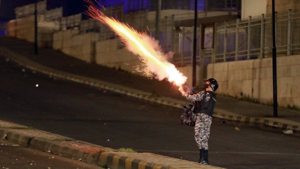 Jordanian security forces disperse a protest in Amman