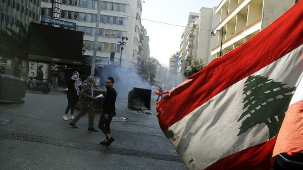 An anti-government demonstrator waves the national flag 
