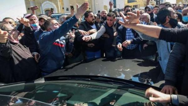 Angry protesters mob an MP's car outside the Salt hospital in Jordan 