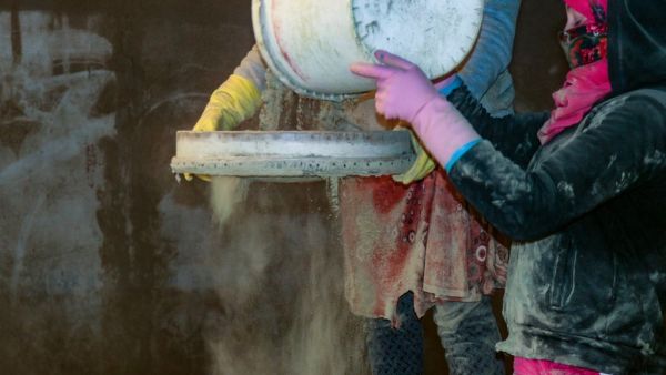 Women sifts dried cannabis to prepare hashish in eastern Lebanon
