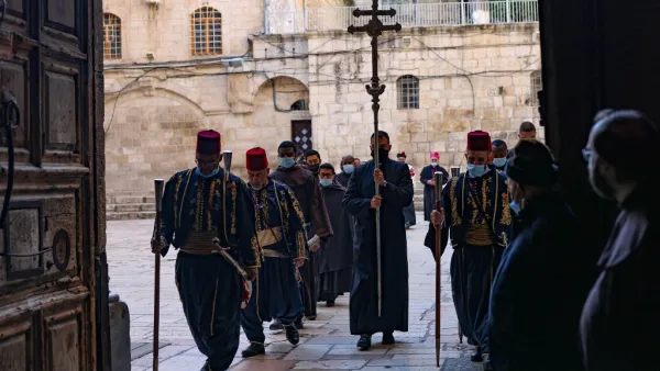 A procession enters the Church of the Holy Sepulchre in Jerusalem