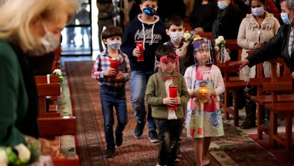 Lebanese Christians, mask-clad due to the coronavirus pandemic