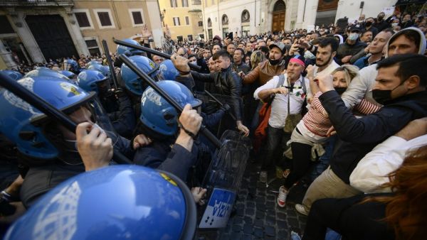 Anti-riot policemen (L) use batons against protesters during skirmishes in a demonstration 
