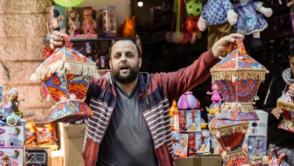 A Palestinian shopkeepers sells lanterns ahead of Ramadan