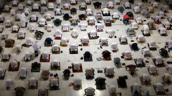 Muslim worshippers perform the evening Tarawih prayer during the fasting month of Ramadan around the Kaaba in the Grand Mosque 