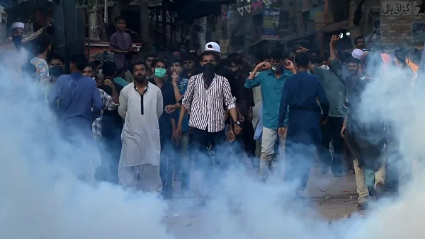 Police fire teargas shell towards supporters of Tehreek-e-Labbaik Pakistan (TLP) party during a protest after their leader was detained following his calls for the expulsion of the French ambassador