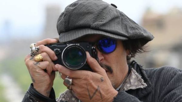 Johnny Depp poses during the photocall of the film "Minamata"