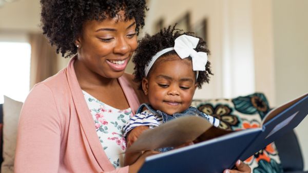 Mother reading a book to her daughter