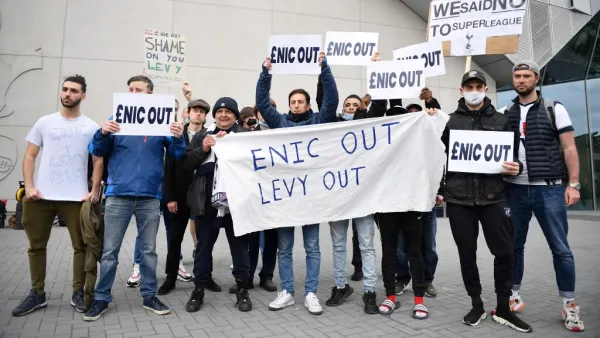 Fans hold posters reacting to the collapse of the planned creation of a European Super League, outside the Tottenham Hotspur Stadium in north London on April 21, 2021 (Photo: AFP)