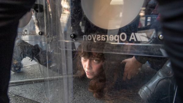 Turkish police detain a demonstrator in clash during May Day 