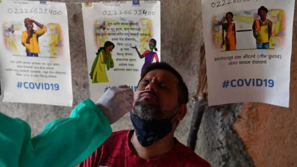 A health worker collects a swab sample from a man for a RT- PCR test at a Covid-19 clinic in Mumbai on May 6, 2021. INDRANIL MUKHERJEE / AFP India sets a new global record of new cases