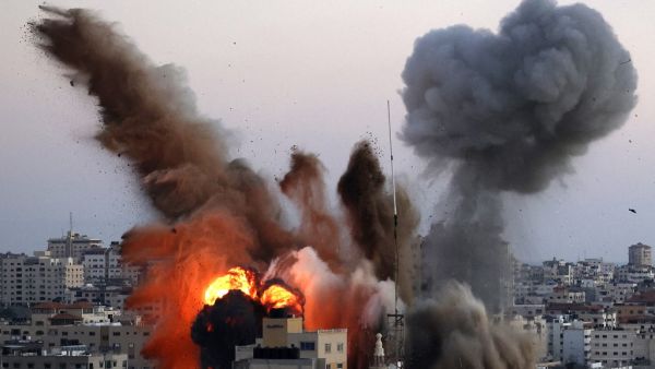Smoke billows after an Israeli airstrike on Gaza City targeted the Ansar compound, linked to the Hamas movement, in the Gaza Strip on May 14, 2021. Israel pounded Gaza and deployed extra troops to the border as Palestinians fired barrages of rockets back, with the death toll in the enclave on the fourth day of conflict climbing to over 100