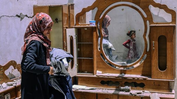 A Palestinian woman searches for the families belongings at their house, after it was destroyed by an Israeli airstrike, in the city of Rafah, in the southern Gaza Strip on May 16, 2021. Israeli strikes killed 33 Palestinians in the Gaza Strip, the worst daily death toll yet in the almost week-long clashes, as the UN Security Council prepared to meet amid global alarm at the escalating conflict. 
