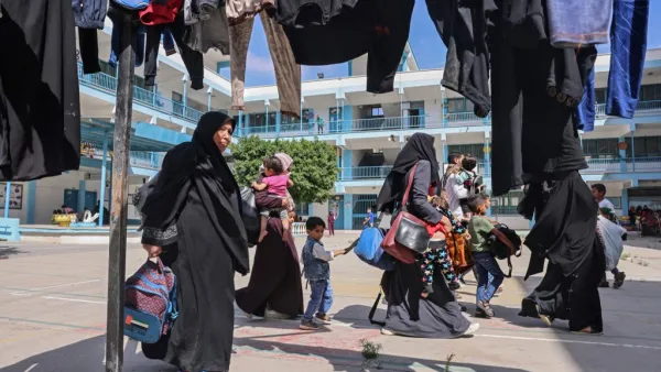 Palestinian families take shelter at a United Nations (UN) school in the southern Gaza Strip city of Rafah, on May 17, 2021, as Israeli air strikes hammered the Gaza Strip after a week of violence that has killed more than 200 people, the large majority Palestinian, despite international calls for de-escalation.