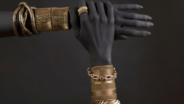 Black woman's hands with gold jewelry