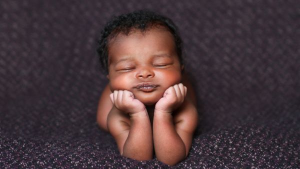 baby resting on her elbows and hands