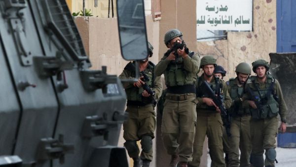 Israeli soldiers walk during a search operation in the village of Salem, east of Nablus, on June 3, 2021, following a reported shooting attack at an Israeli driver near the Allon Moreh settlement, in the occupied West Bank