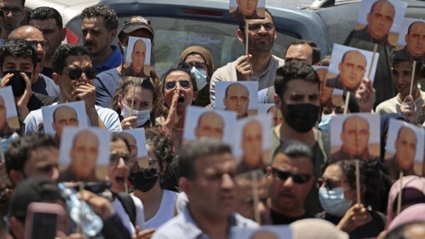 Protesters take part in a demonstration calling for Palestinian president Mahmud Abbas to quit in Ramallah in the occupied West Bank on June 24, 2021, following the death of Palestinian human rights activist Nizar Banat who died shortly after being arrested by Palestinian Authority (PA) security forces. The family of Nizar Banat claimed he was beaten to death, sparking condemnation from human rights activists, marches in the West Bank city of Ramallah, and calls for an inquiry