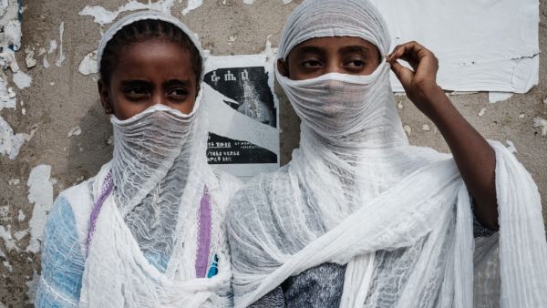 Young Ethiopian Orthodox worshippers watch people dancing and praying for peace at St. Mary church in Mekele, the capital of Tigray region, 