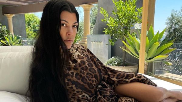 Kourtney highlighted her flat tummy in the black string bikini