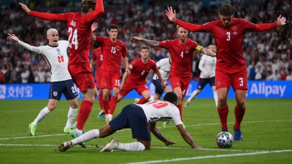 England's forward Raheem Sterling (C) falls on the ground which led to the awarding of a penalty during the UEFA EURO 2020 semi-final football match between England and Denmark at Wembley Stadium in London on July 7, 2021. (Photo: AFP)