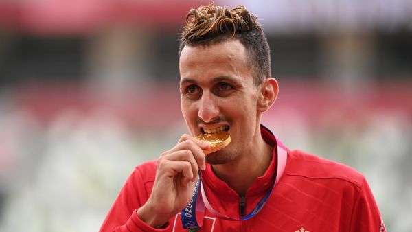 First-placed Morocco's Soufiane El Bakkali celebrates on the podium with his gold medal after competing in the men's 3000m steeplechase event during the Tokyo 2020 Olympic Games at the Olympic Stadium in Tokyo on August 3, 2021. (Photo: AFP)