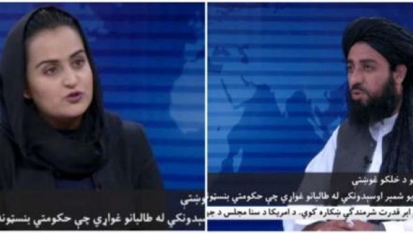 Wanita Pertama interviewing a Taliban official 