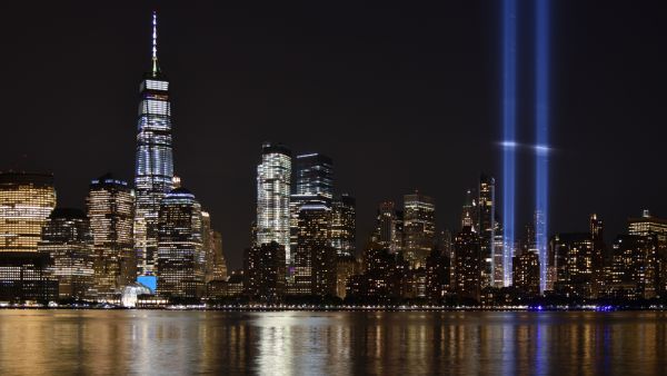 The 9/11 Tribute in Lights temporary monument in lower Manhattan dominates the city skyline.