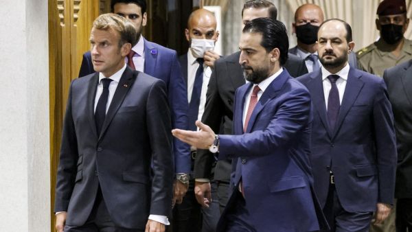 Iraqi Parliament Speaker Muhammad al-Halbousi (R) receives France's President Emmanuel Macron