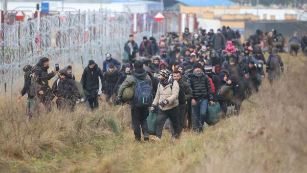 Hundreds of desperate migrants are trapped in freezing temperatures on the border and the presence of troops from both sides has raised fears of a confrontation. (Photo by Leonid Shcheglov / BELTA / AFP) Belarus funneled Middle Eastern migrants to seek refuge in EU