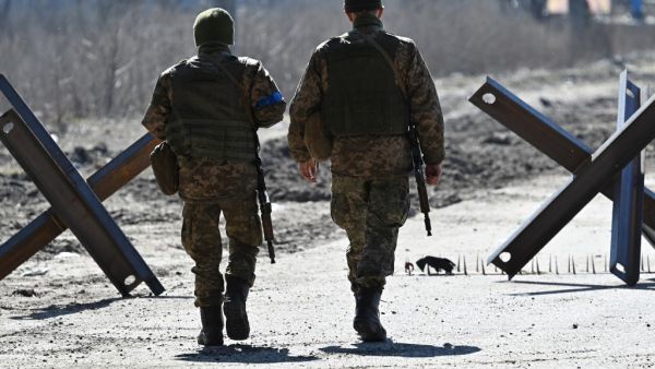 Ukrainian soldiers walk on the front line 