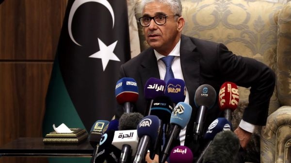 Libyan interim prime minister Fathi Bashagha, newly named by the Libyan parliament, delivers a speech at Mitiga International Airport in Tripoli on February 10, 2022.(Photo by Mahmud Turkia / AFP) Libyan interim prime minister Fathi Bashagha