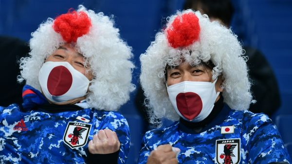 Japanese supporters pose before the start of the FIFA World Cup Qatar 2022 Asian zone qualification football match between Japan and Saudi Arabia at Saitama Stadium in Saitama on February 1, 2022. (Photo by Philip FONG / AFP)