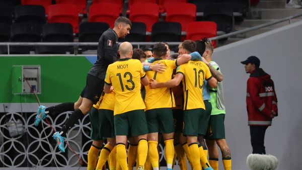Australia's players celebrate after scoring a goal during the FIFA World Cup 2022 play-off qualifier football match between UAE and Australia at Ahmad bin Ali stadium in Qatar's Ar-Rayyan on June 7, 2022. (Photo by KARIM JAAFAR / AFP)