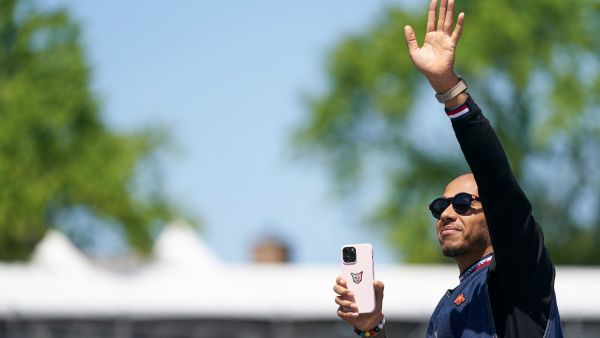 Mercedes' British driver Lewis Hamilton waves to the crowd during the parade of drivers, ahead of the Canada Formula 1 Grand Prix on June 19, 2022, at Circuit Gilles-Villeneuve in Montreal. (Photo by Geoff Robins / AFP)