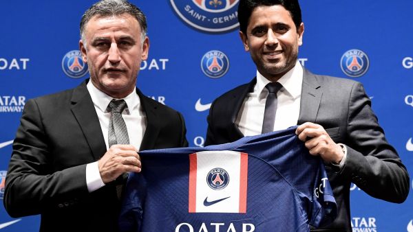 French coach Christophe Galtier (L) and PSG's President Nasser Al-Khelaifi (R) holds a jersey as they pose at the end of a press conference after Galtier was appointed as French L1 football club Paris Saint-Germain's (PSG) head coach, at the Parc des Princes stadium in Paris on July 5, 2022. (Photo by BERTRAND GUAY / AFP)