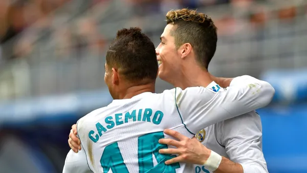 Real Madrid's Portuguese forward Cristiano Ronaldo (R) celebrates with Real Madrid's Brazilian midfielder Casemiro after scoring a goal during the Spanish league football match between Eibar and Real Madrid at the Ipurua stadium in Eibar on March 10, 2018. (Photo by ANDER GILLENEA / AFP)